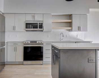 a kitchen with stainless steel appliances and white cabinets